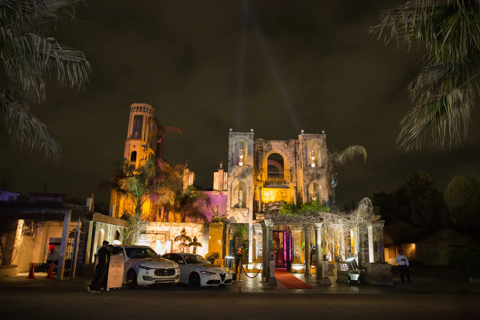 The villa's façade lit up at night